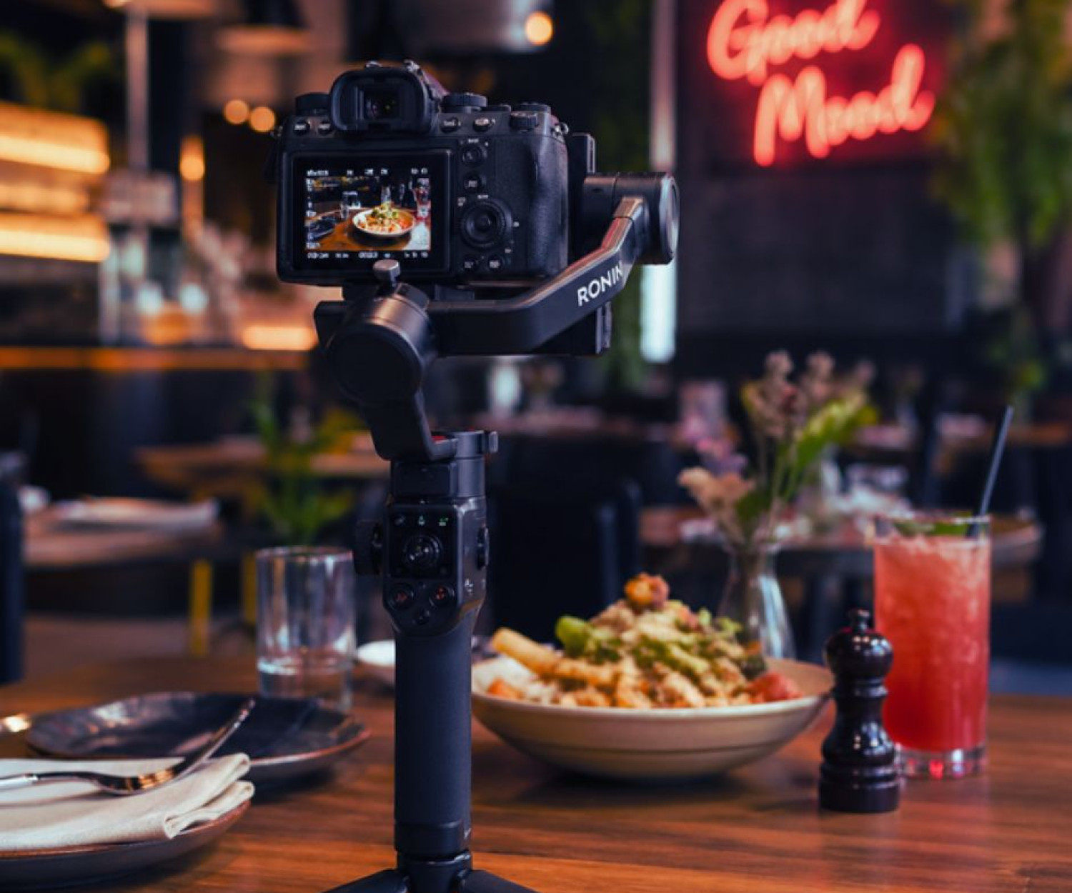 Camera and Gimbal sitting on a table in a restaurant.