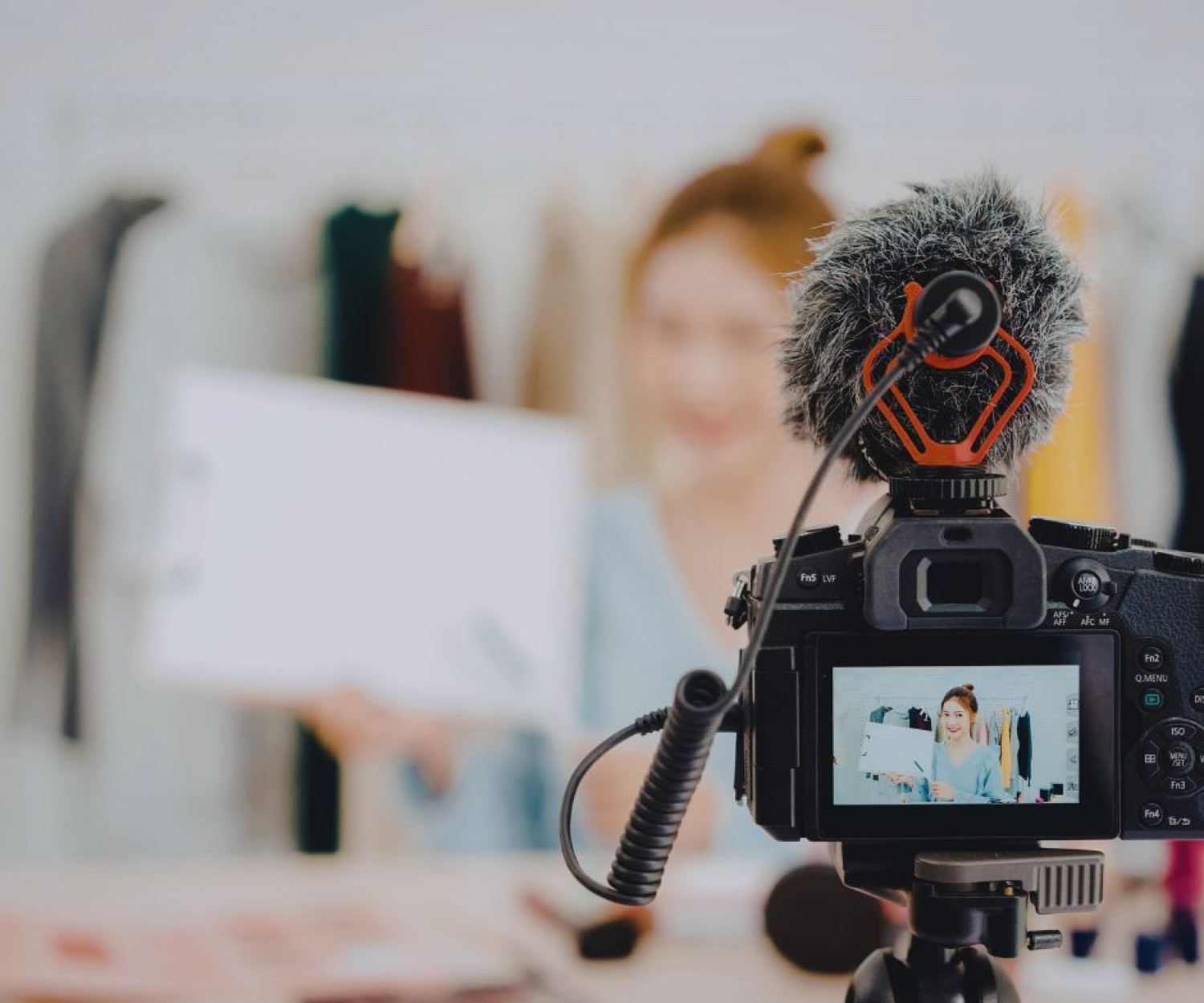 Professional video production Auckland — camera in focus filming a presenter holding document for social media reel shoot